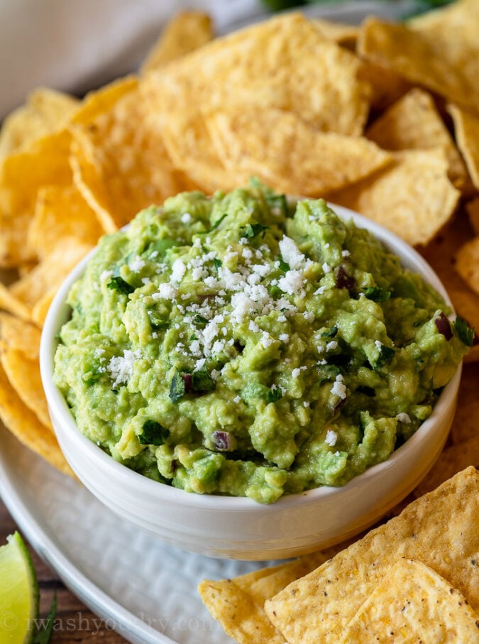 Top your Authentic Guacamole Recipe with fresh cotija cheese and serve with tortilla chips!