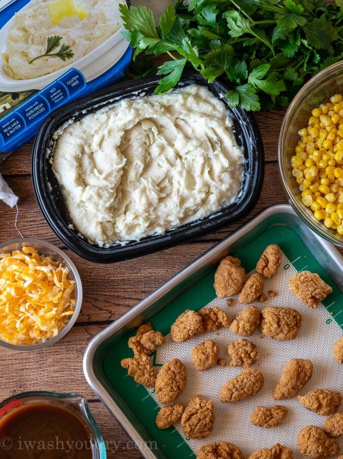 Combine the mashed potatoes, cheese, corn, crispy chicken and gravy in a bowl and dinner is served!