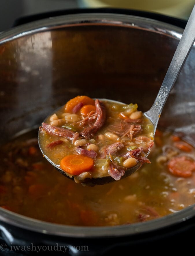 Once the Ham Bone and Bean Soup is cooked, pull out the ham bone and discard. Add the ham back to the soup and stir to combine.