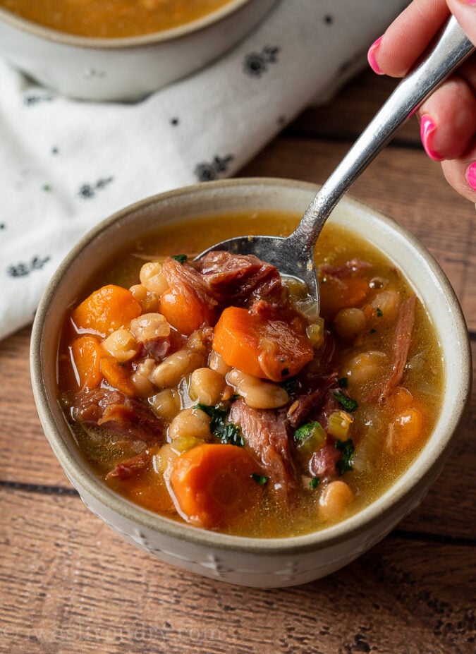 YUM! This super easy Instant Pot Ham Bone Soup is filled with navy beans and veggies! Perfect for using up leftover ham!