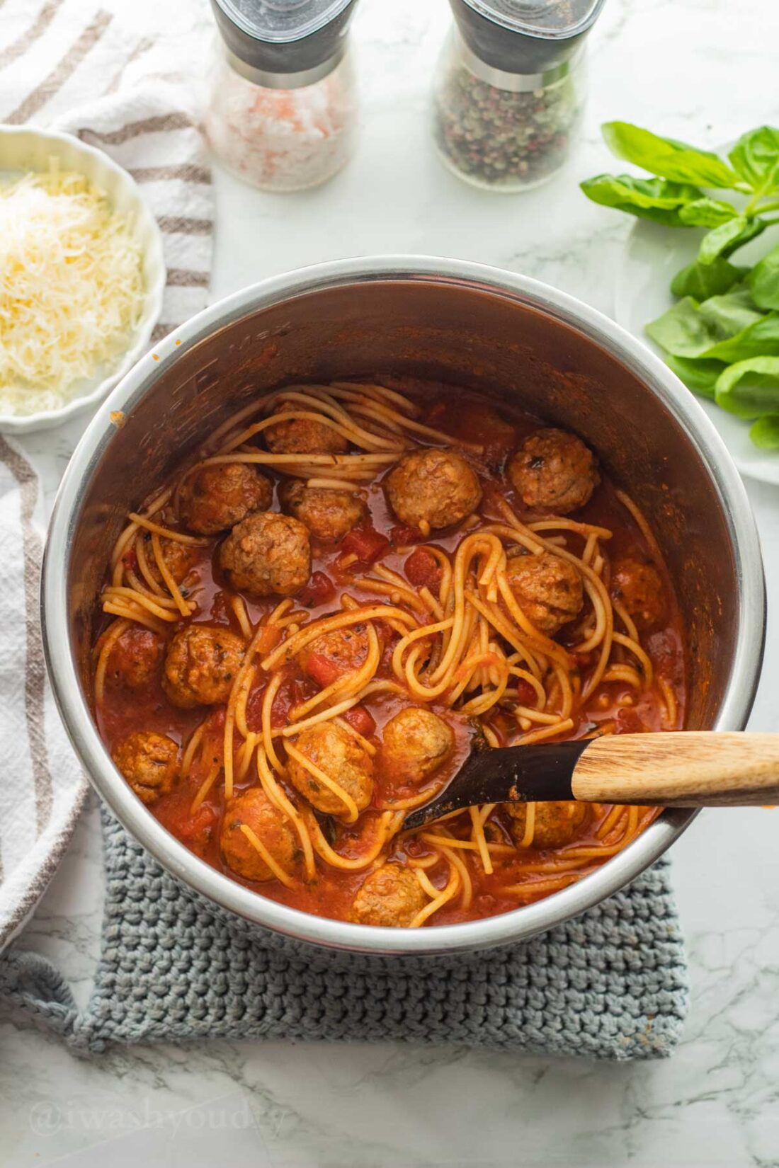 Cooked spaghetti and meatballs with spoon in instant pot. 