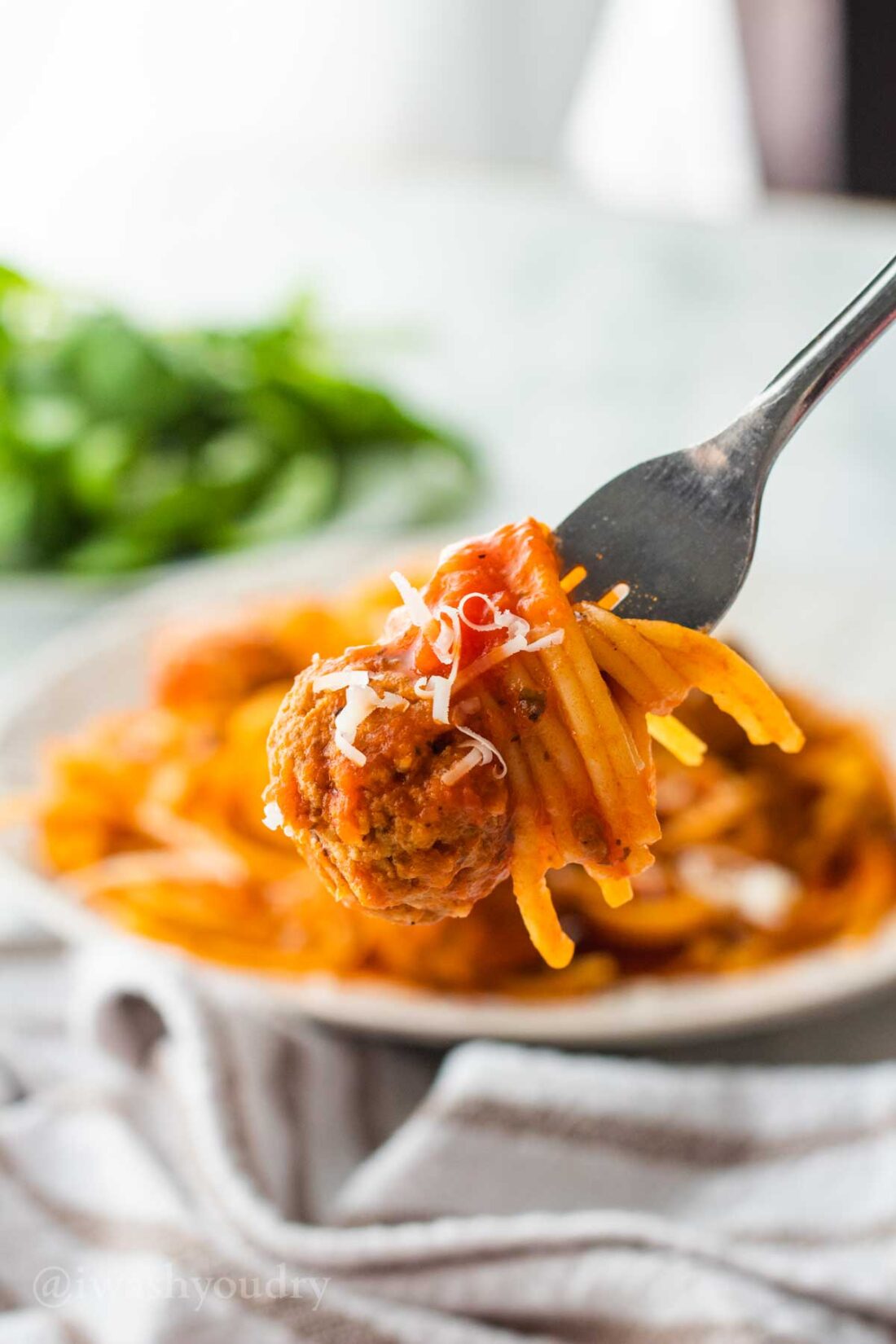 Bite of spaghetti and meatballs on a fork.