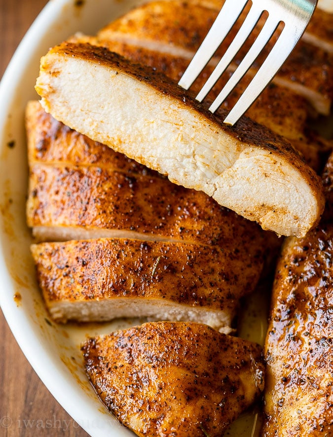 Slice of juicy oven baked chicken breast on a fork