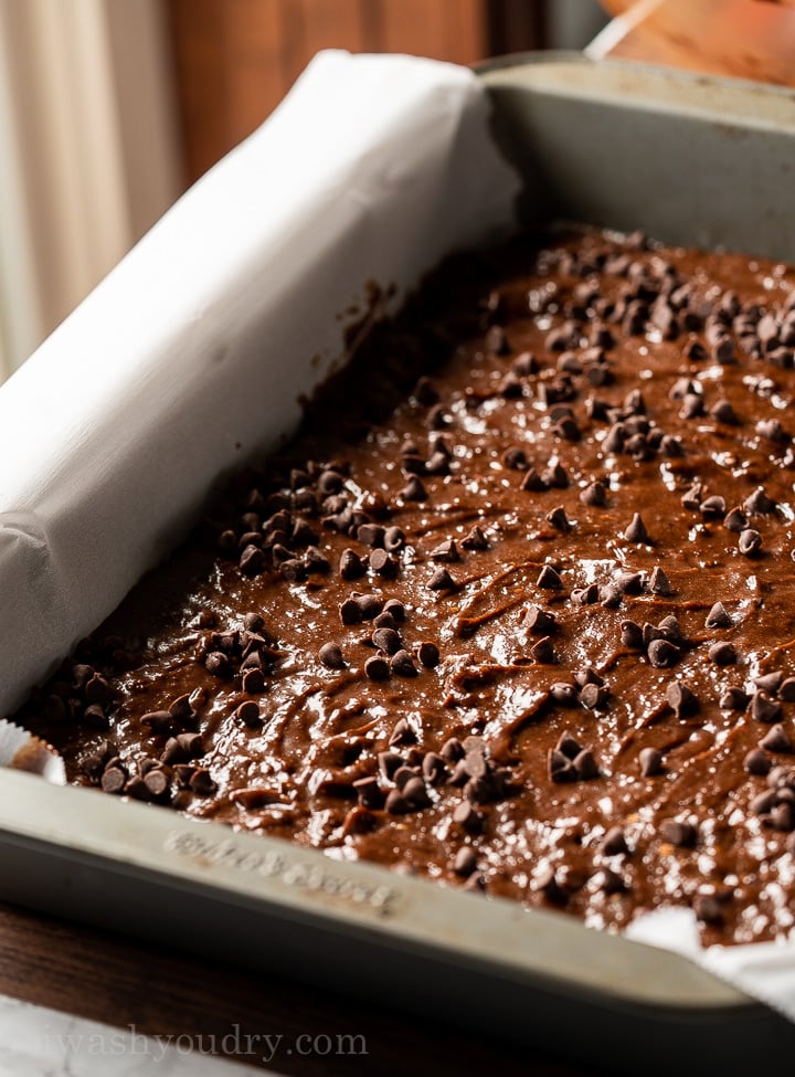 brownie batter in baking pan with parchment paper