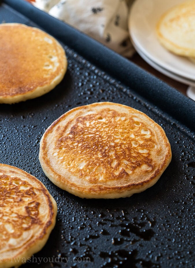 Cook Homemade Pancakes in butter on a hot griddle until they're golden brown on each side.