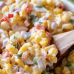 This Creamy Corn Salad Recipe is a quick and easy side dish that's filled with crisp corn kernels that pop in a creamy sauce; perfect for summer potlucks and bbq's!