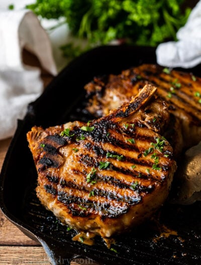 grilled pork chops on pan with parsley