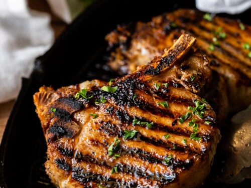 grilled pork chops on pan with parsley