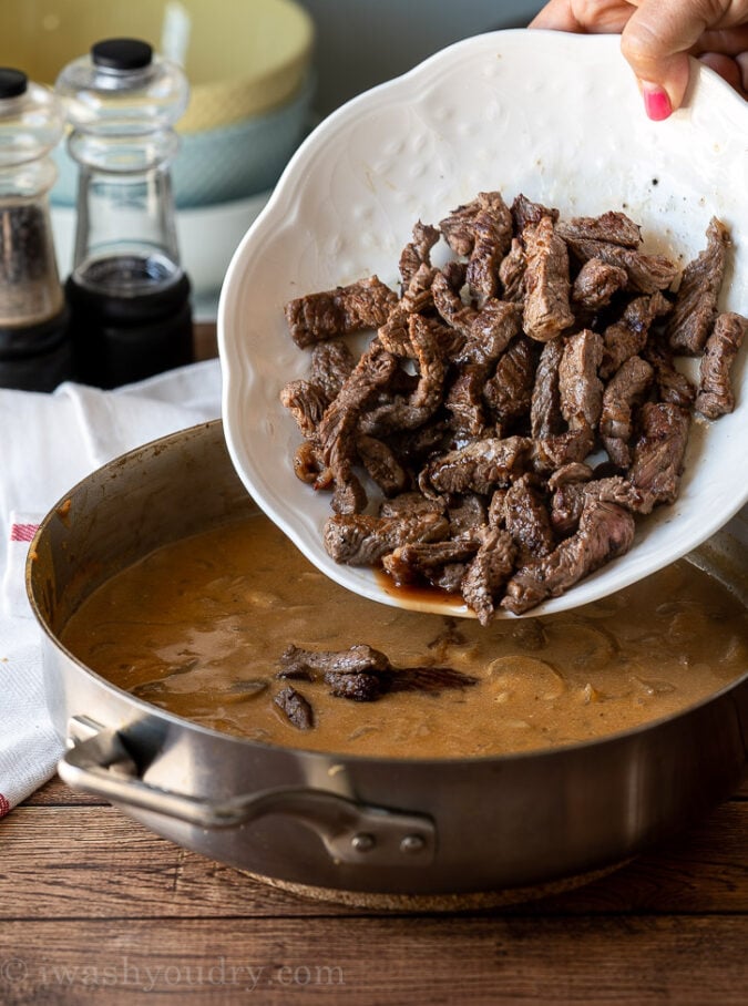 Once you've made your gravy, add the steak strips and juices back into the pan.