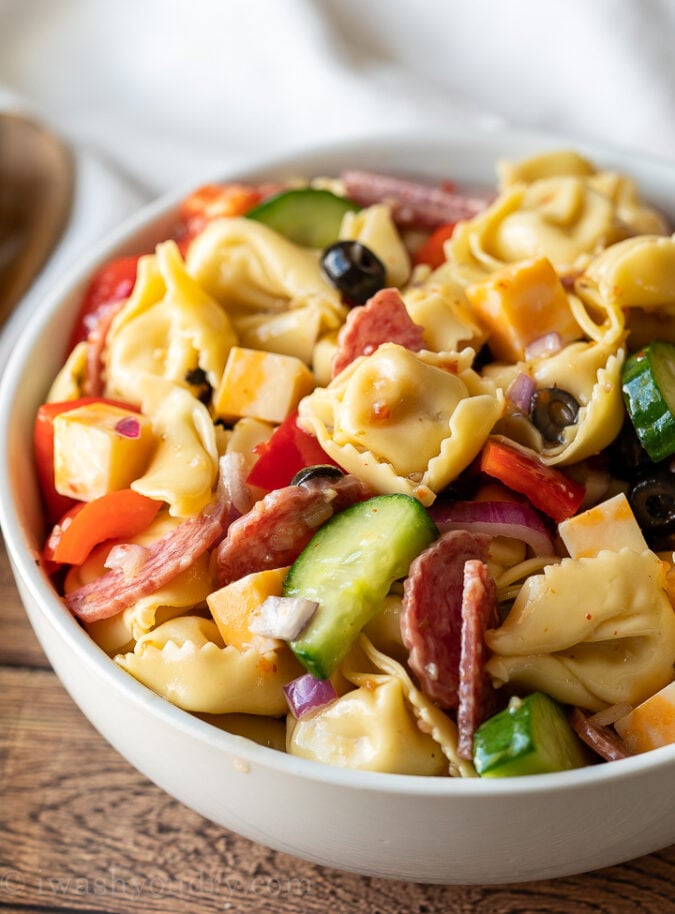 This tortellini recipe is filled with loads of delicious pasta salad goodies and tossed in a zippy dressing! Perfect for summer potlucks and parties!