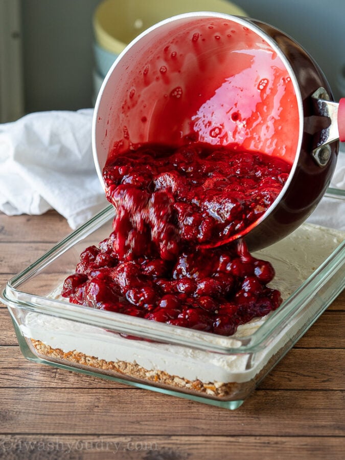 Combine jello mix with hot water and then add in the frozen raspberries.