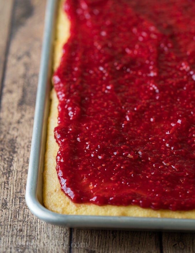 Top the Vanilla Cake Recipe with the Raspberry Cake Filling once both are cooled.