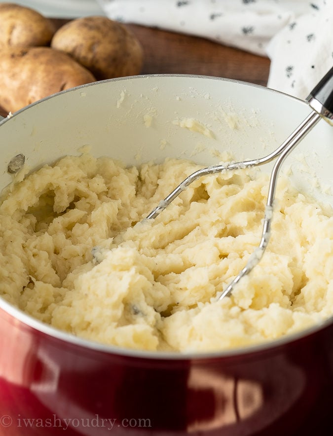 Use a hand masher to mash the potatoes to your desired consistency