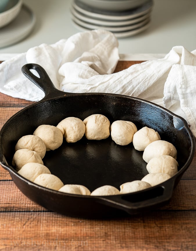 Line the outer edge of the skillet with refrigerator biscuits.