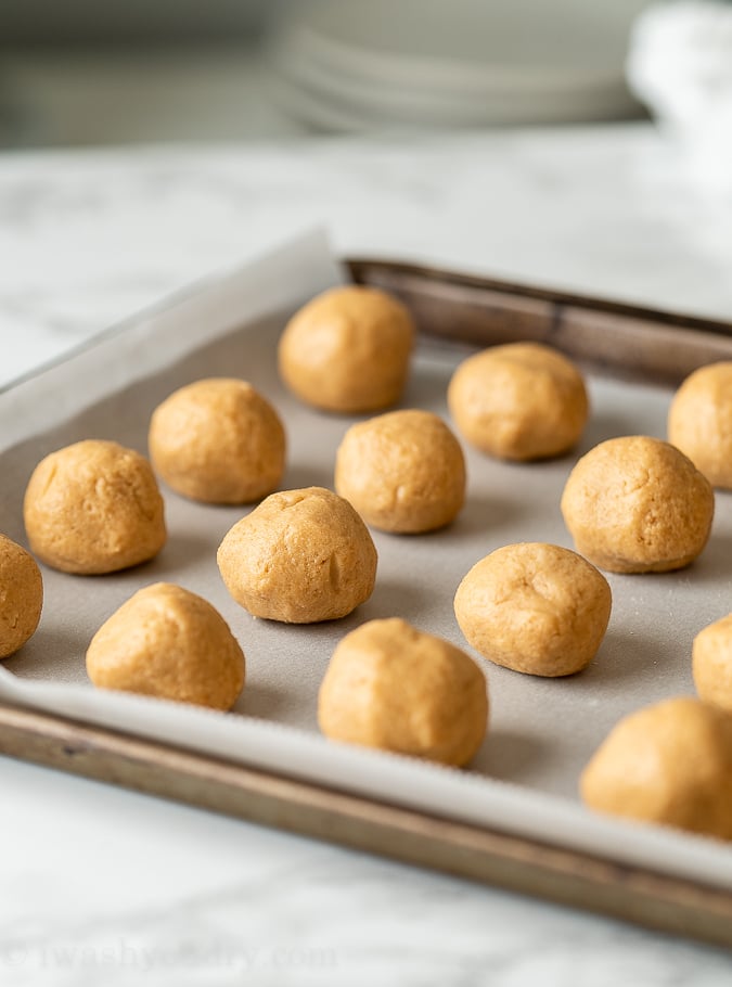 Once rolled into balls, place the peanut butter balls in the freezer or fridge to firm up.