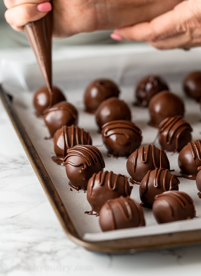 Decorate the tops of the peanut butter balls with extra chocolate if desired.