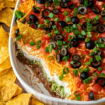 A layered dip on plate of food
