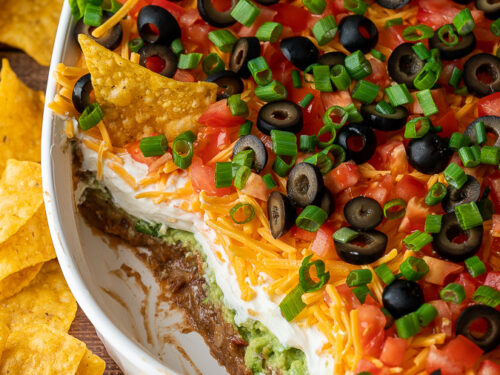 A layered dip on plate of food