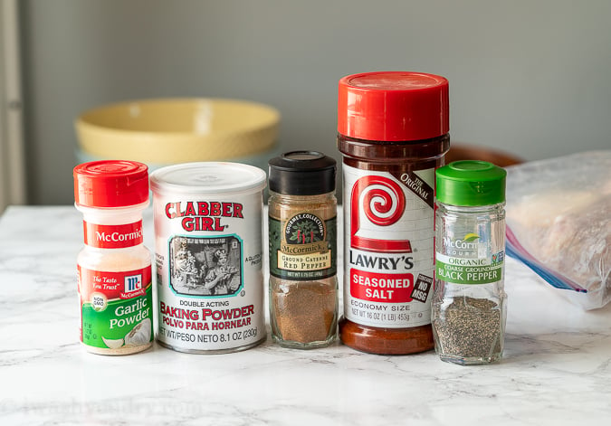 Spices lined up on counter, used for coating baked chicken wings.