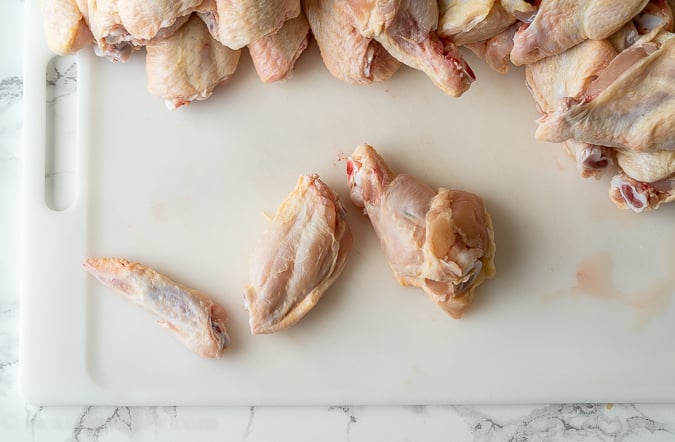 The different parts of a chicken wing on a cutting board