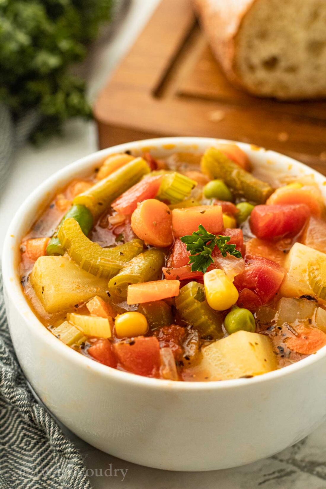 white bowl filled with soup and vegetables.