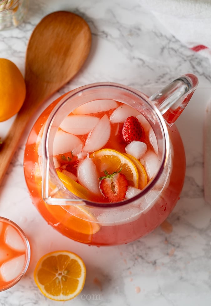 Top down image of Strawberry Lemonade in a large pitcher.