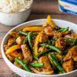 This quick and easy Honey Sesame Chicken Stir Fry is filled with tender chicken breast strips, green beans and yellow peppers in a sweet and sticky sauce.