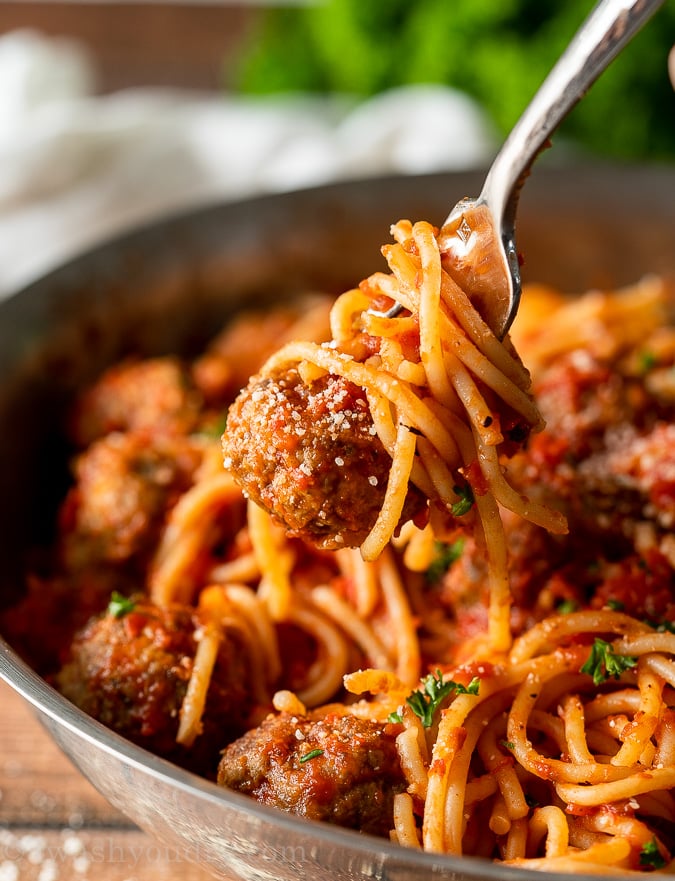 Meatball and spaghetti twirled on fork.