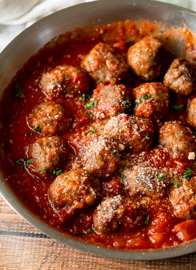A close up of a bowl of food, with Meatball