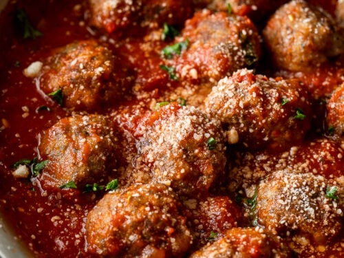 Easy Meatball Recipe in marinara sauce, topped with parmesan cheese