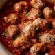Easy Meatball Recipe in marinara sauce, topped with parmesan cheese