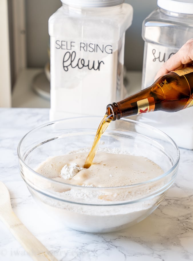 Pour beer into the flour mixture and stir until combined.