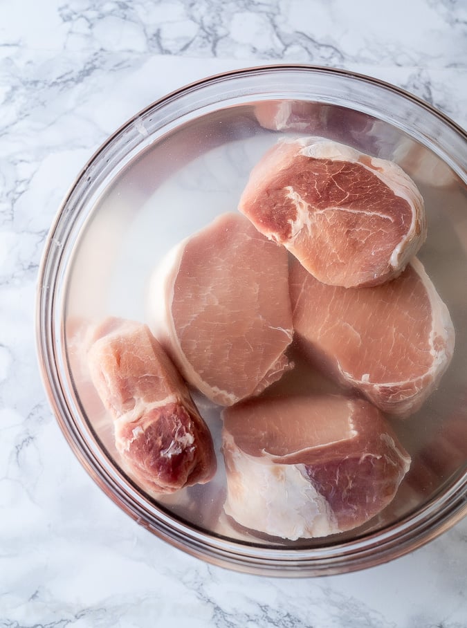 In order to get ultra juicy and tender baked pork chops, make sure to brine the pork in either a dry brine or wet brine for at least 30 minutes.
