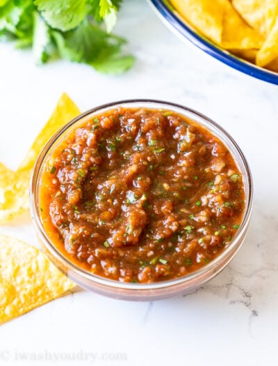 A bowl of food on a plate, with Salsa