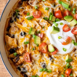 Close up image of Chicken Black Bean Enchiladas in a white pan.