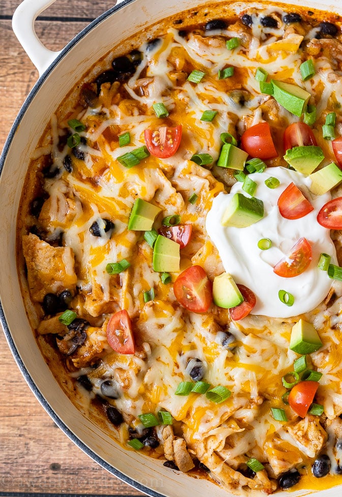 Close up image of Chicken Black Bean Enchiladas in a white pan.