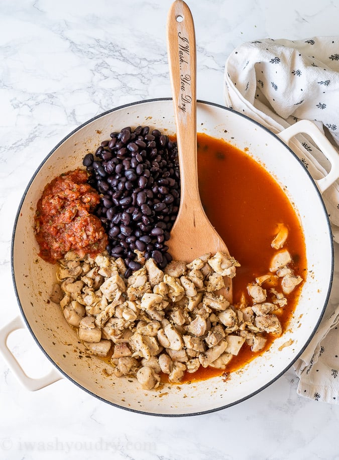 Ingredients needed for Chicken Enchilada Skillet in a large white skillet.