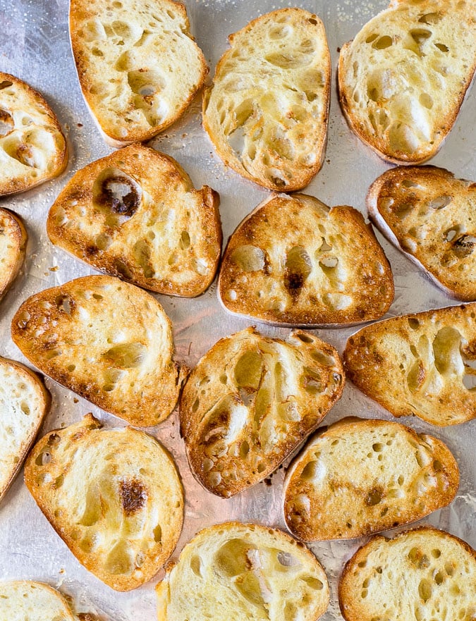 Toasted baguette pieces used for bruschetta topping.