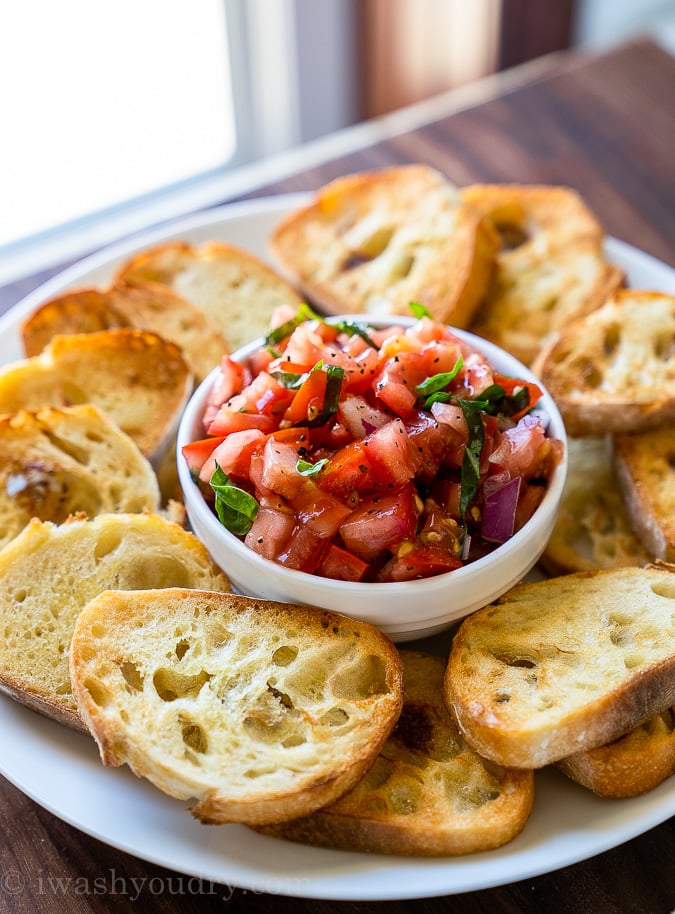 This Easy Bruschetta Recipe is made with fresh tomatoes, basil and onion then served over crisp baguette bread.