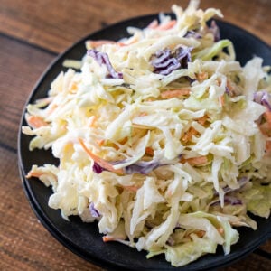Black plate filled with creamy Coleslaw recipe.