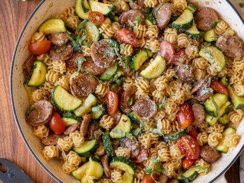 Chicken sausages, zucchini, tomatoes and pasta in a large skillet