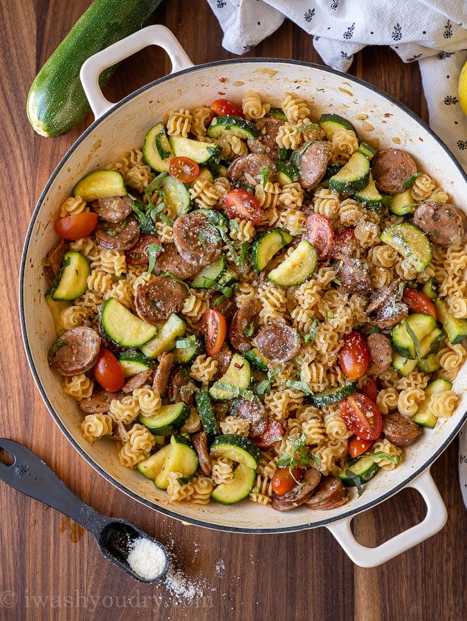 Chicken sausages, zucchini, tomatoes and pasta in a large skillet