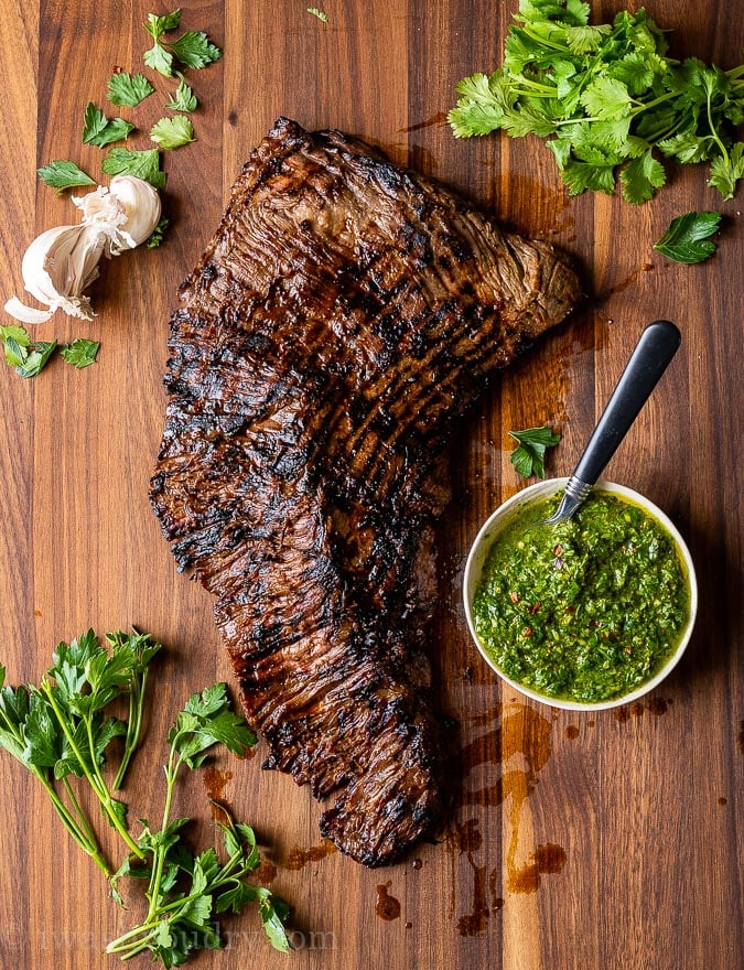 Resting the skirt steak on a cutting board before slicing.