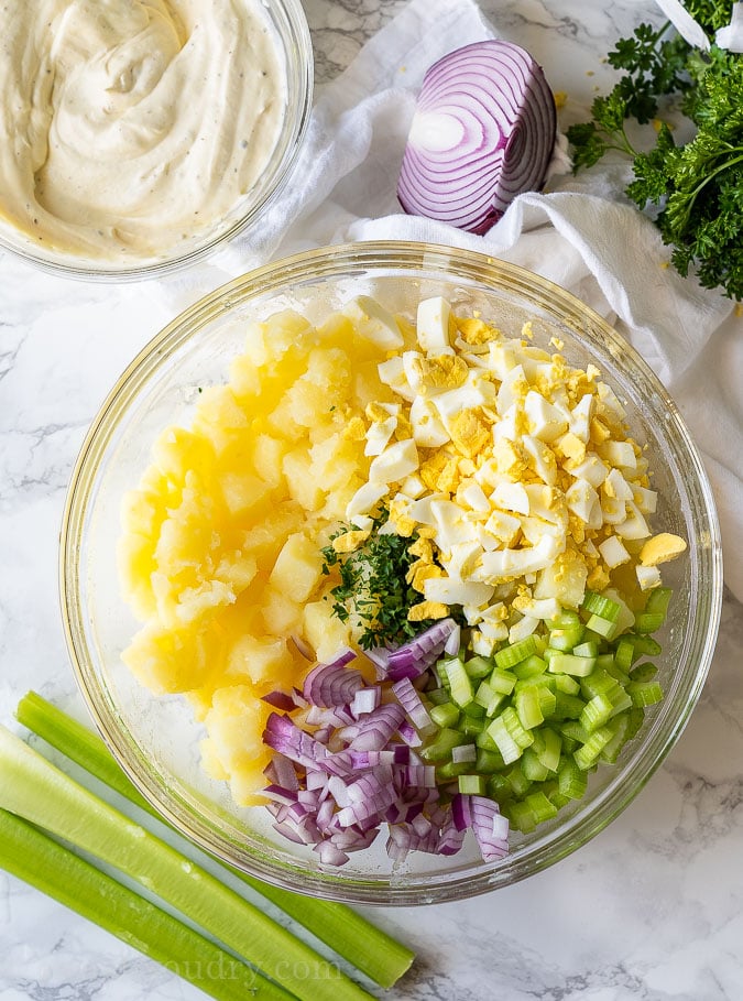 Potato salad ingredients in a large mixing bowl