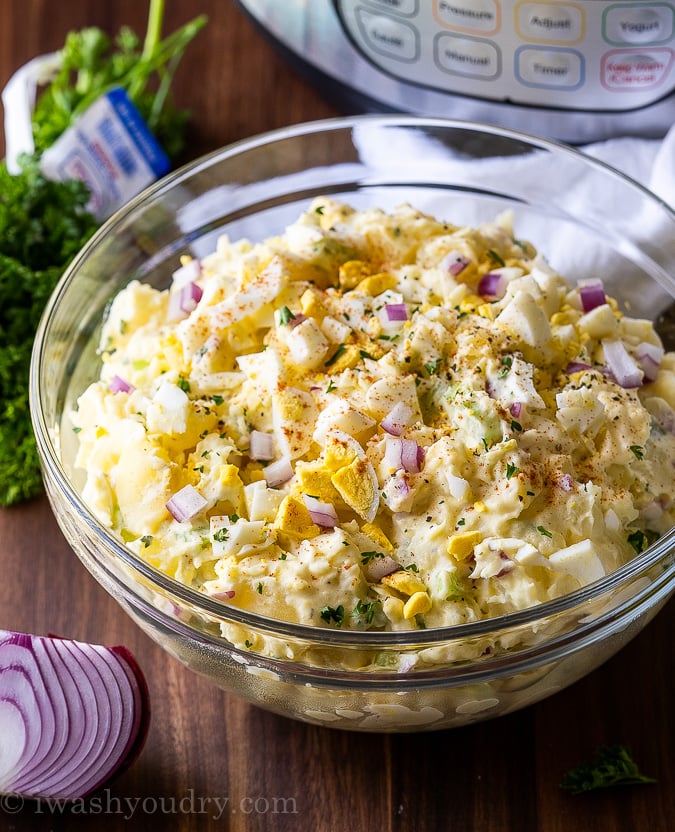 Potato Salad in large bowl with hard boiled eggs on top.