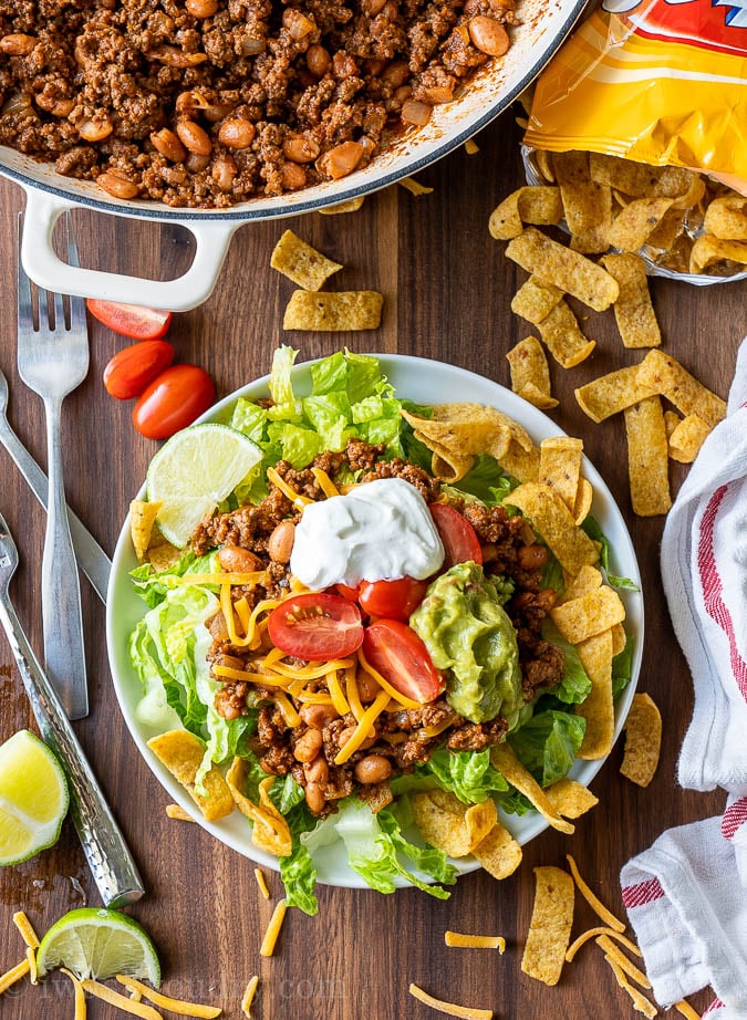 Plate full of taco salad with taco toppings.