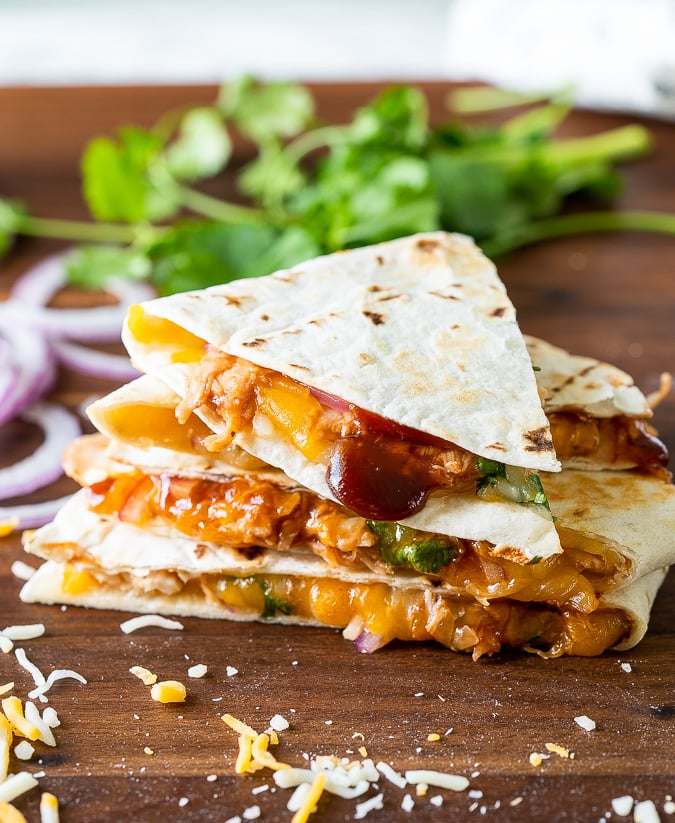 Sliced bbq chicken quesadilla on cutting board