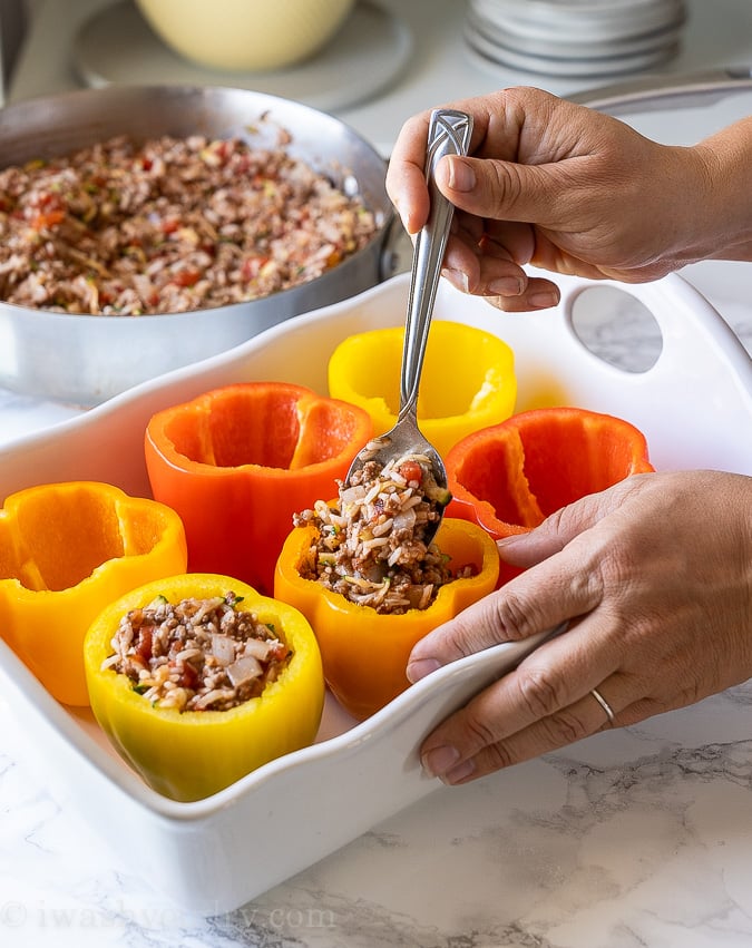 Add ground beef and rice mixture to the bell peppers.