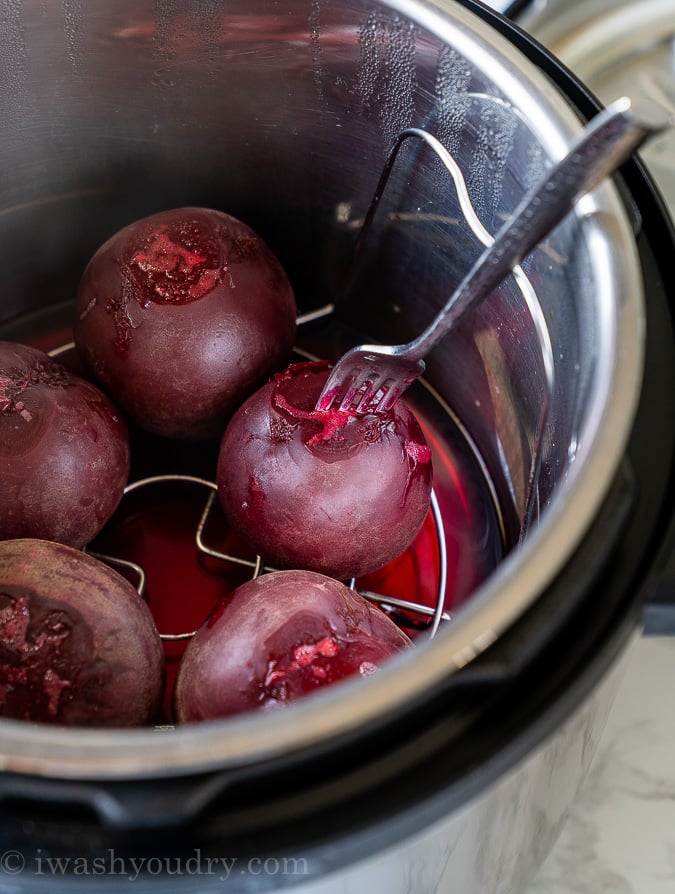Test cooked beets in pressure cooker with a fork for doneness.