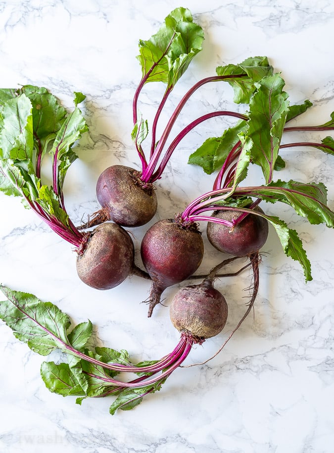 Similar size beets on a marble top